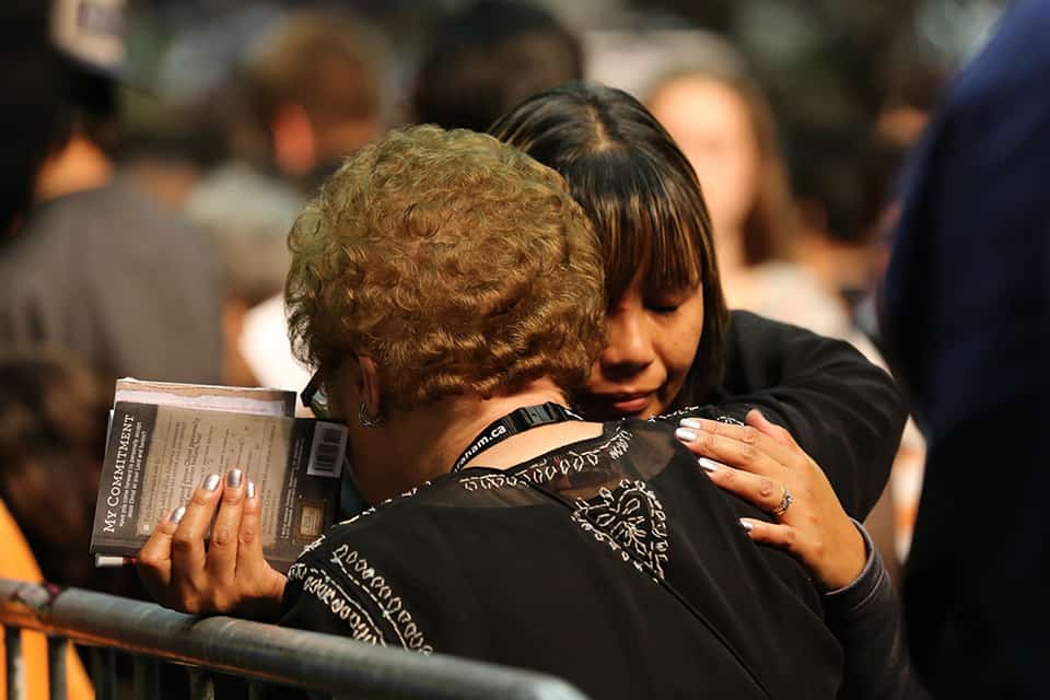 Festival counselor hugs woman