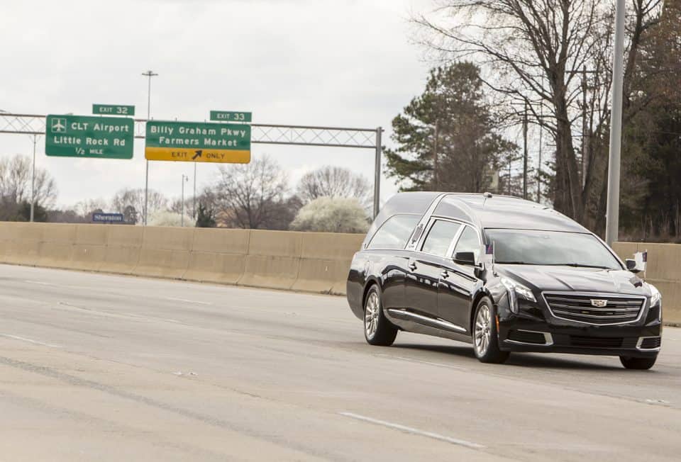 In the background, an exit sign for Billy Graham Parkway.