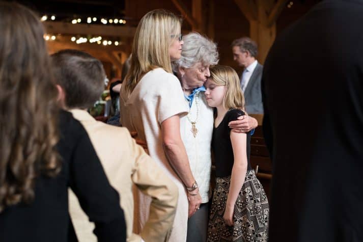 Jean Graham Ford, Billy Graham’s little sister, gives her granddaughter a hug in the Billy Graham Library, where a private family ceremony was held on Saturday afternoon.