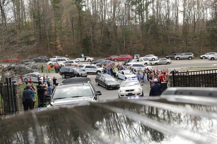 People waved and some captured the moment with their phones as the motorcade pulled off Billy Graham Parkway and into the Billy Graham Evangelistic Association headquarters in Charlotte, North Carolina.