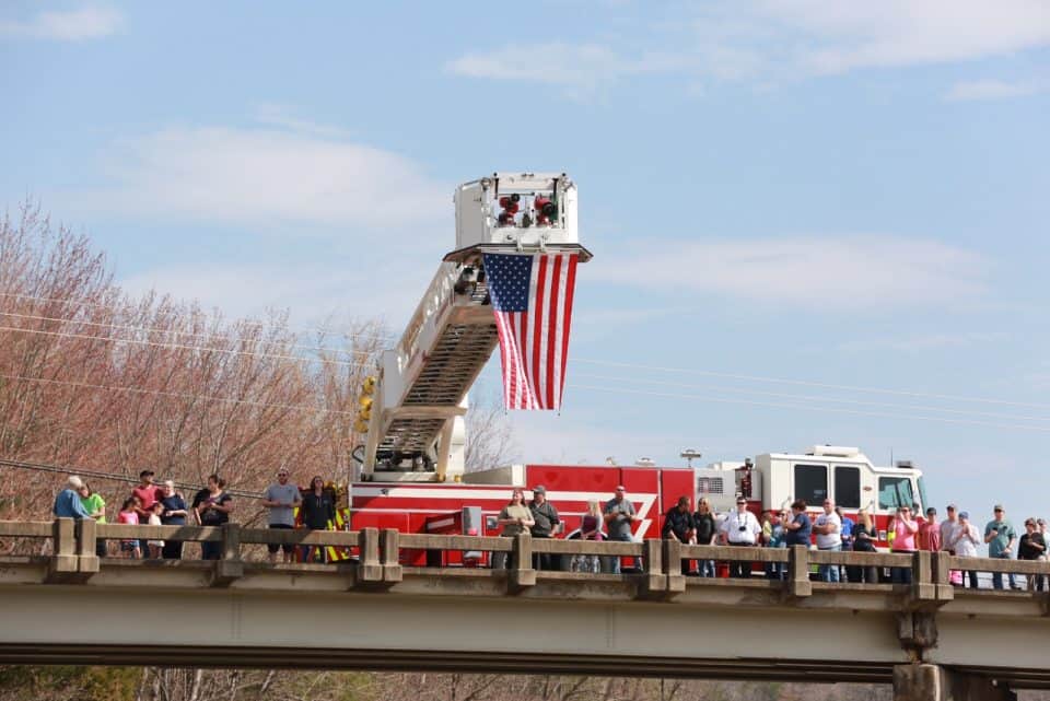 Many people who came out to view the motorcade said a hush came over the area as the hearse passed by.