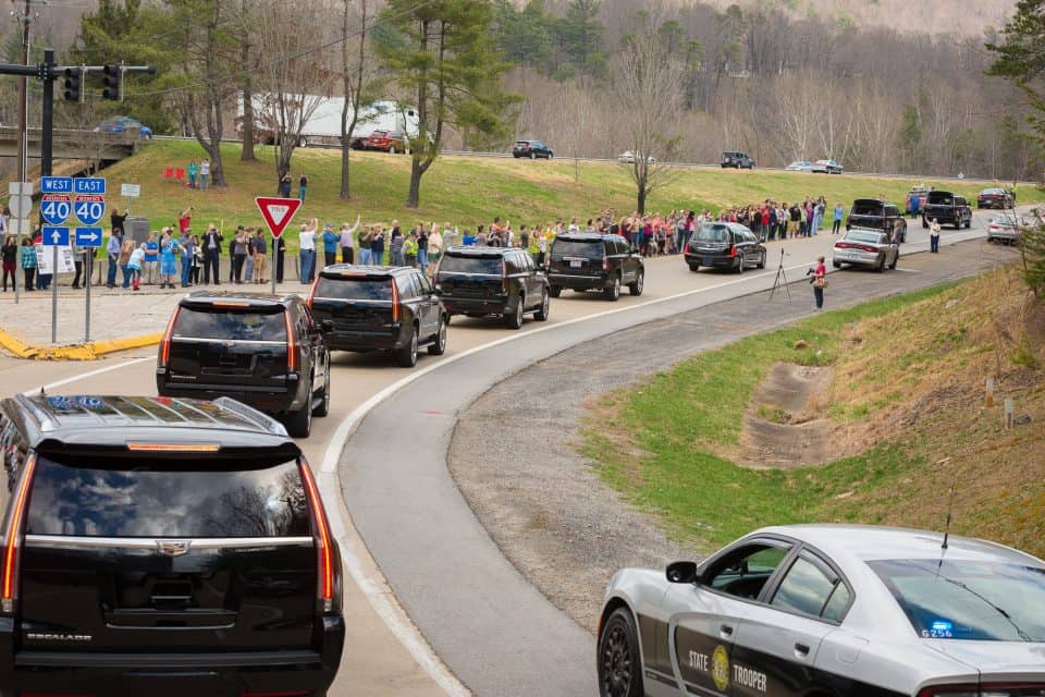 People parked near the entrance of The Cove and stood by the road to pay their respects as Mr. Graham's hearse passed by on its way to Charlotte, where he was born and raised. "My father made me promise long ago that we would take him back to Charlotte after he died, and that’s what we’re in the process of doing right now," Franklin Graham said on Saturday.