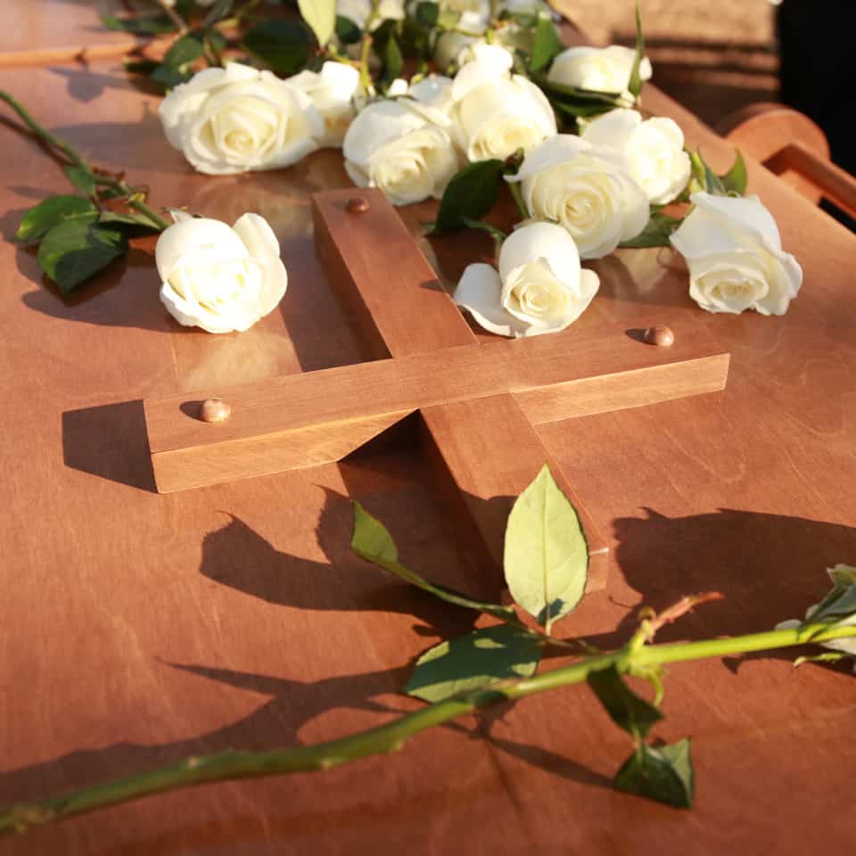 Family members placed white roses on Billy Graham's casket after the private interment ceremony.
