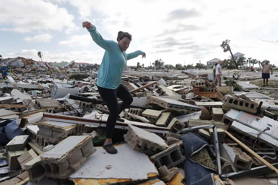 A woman searches through the rubble for her friend, who stayed behind during the storm.