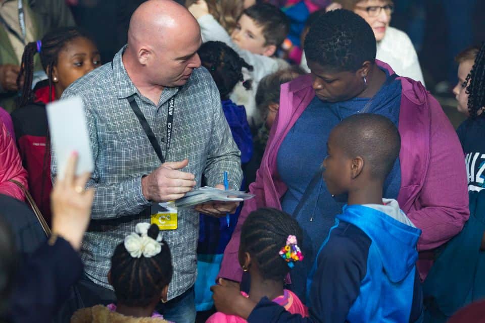 A counselor explains the Gospel to a family who came forward during the invitation to accept Jesus.