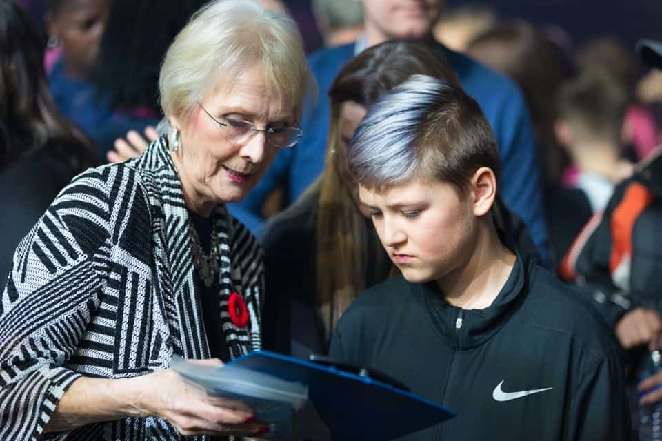 A local adult counselor talks about the Gospel with a student.