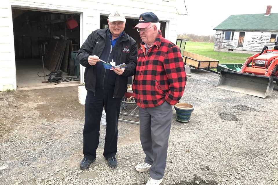 Rapid Response team chaplains, Rick Benner (right), explaining the Gospel to a flood victim in New Brunswick.