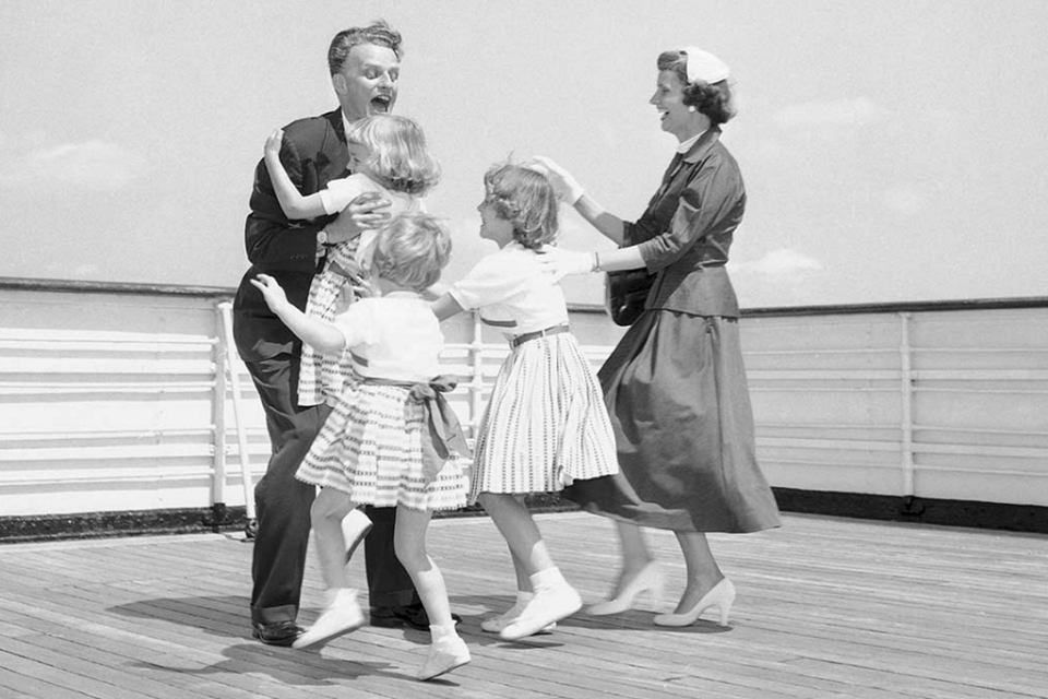 Billy Graham reunites with his daughters and wife after a five-week evangelistic outreach in 1954.