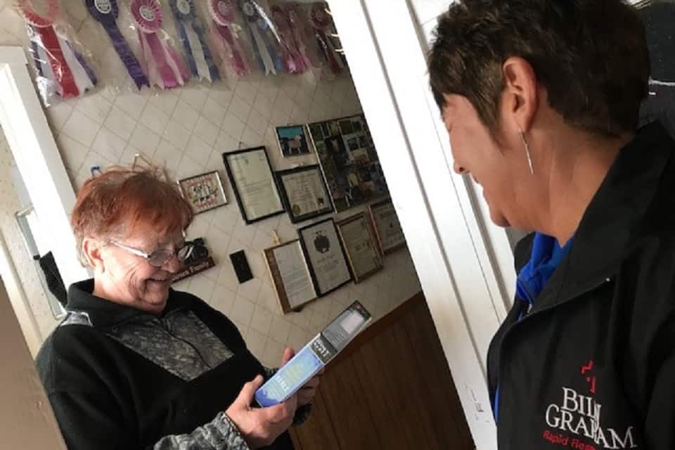 PEI resident receives a bible from an RRT chaplain after accepting Jesus as their personal savior.