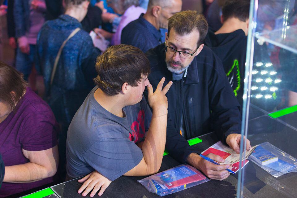 A volunteer counselor (right) shares the Gospel with a young man during the Quinte Celebration of Hope at CAA Arena in Belleville, ON.