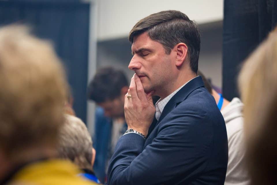 Will Graham spends time in prayer with others before the final night of the Quinte Celebration.