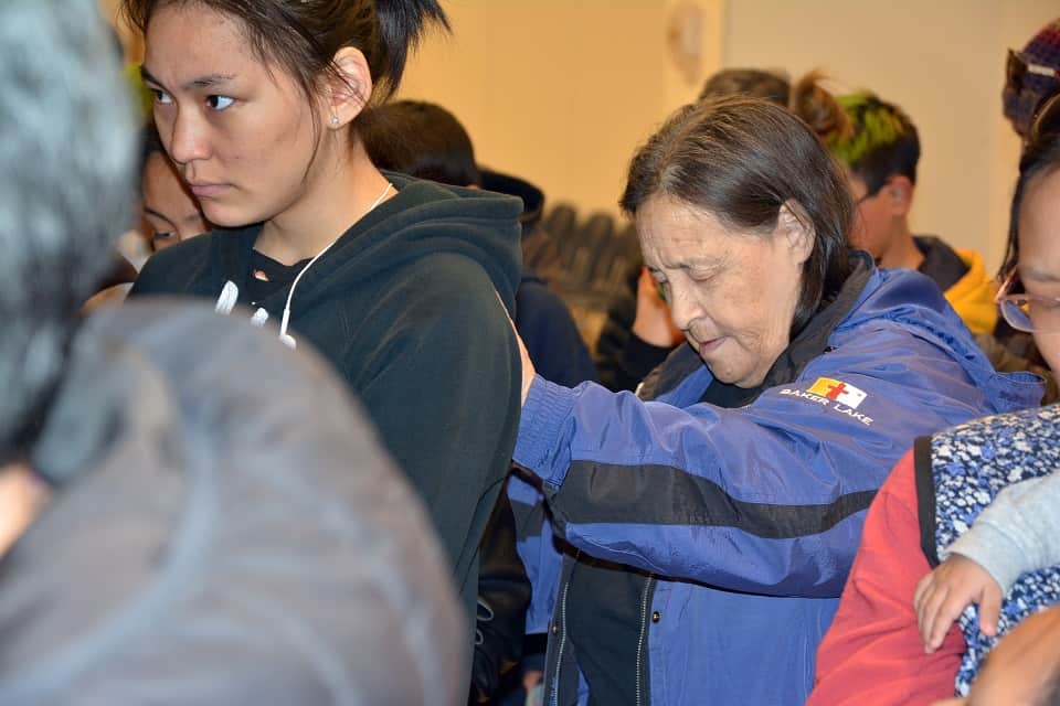 Winnie Tepatai (right) praying for members of her community in Baker Lake to attend the Celebration of Hope with Will Graham. The event is set to take place October 26 and 27 at the Qamanittuaq Recreation Centre.