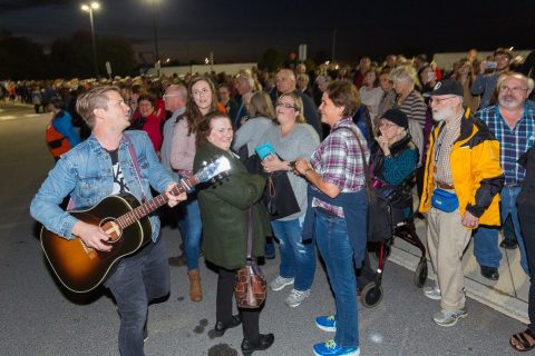 Josh Havens (left), lead singer of The Afters, leading worship in the parking lot during the temporary evacuation of CAA Arena. 