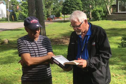 Harvey, a BG-RRT chaplain, prepares to give a special Billy Graham Bible to an Ottawa resident.