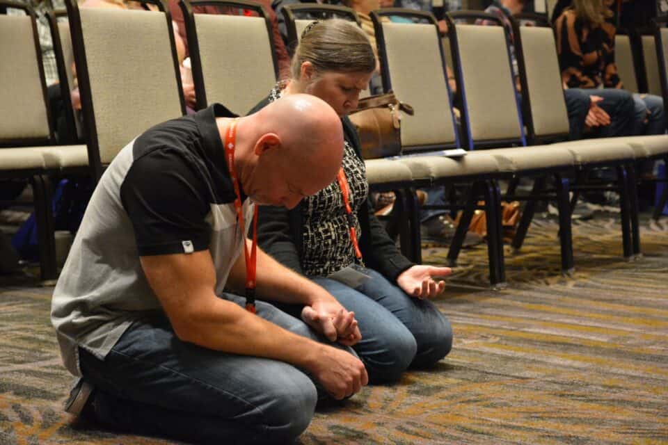 Bruce and Sheryl Ewanyshyn share a moment in prayer.