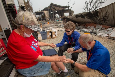 RRT chaplains praying with woman who lost her home in wildfires