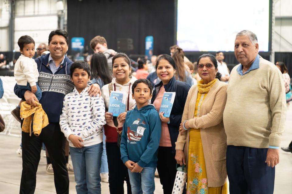 Three generations of the Josh* family attended Momentum together. “I especially pray for the young people, that they will come and follow Jesus Christ and change their life,” said Josh (left, holding son). He hopes the Celebration will help break the bondage of addiction he observes in Regina’s next generation.